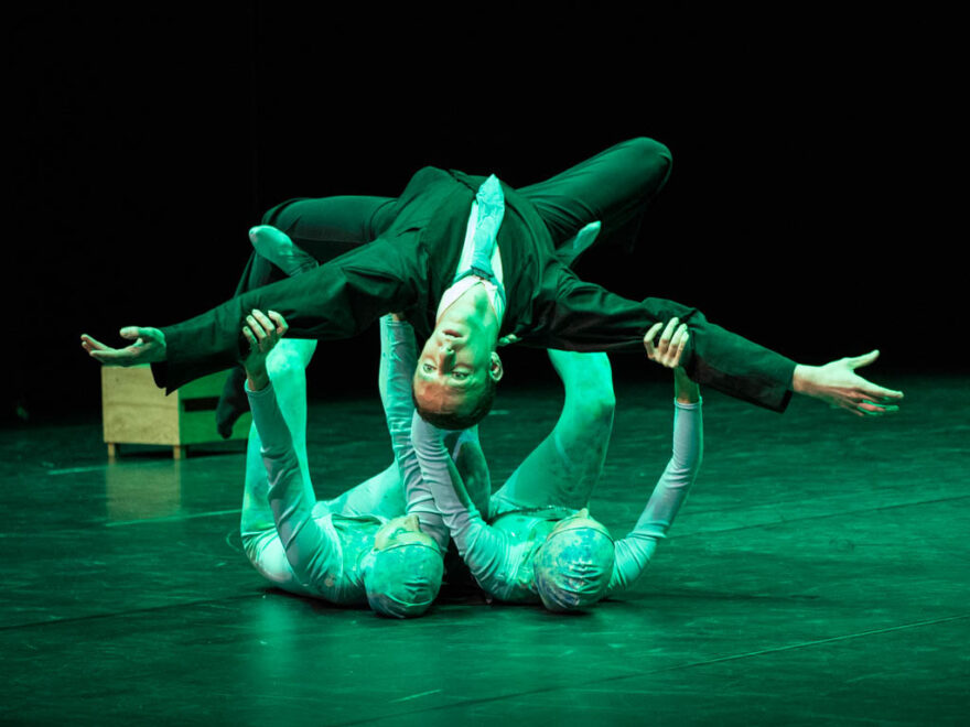 Scene of a contemporary dance show with three dancers