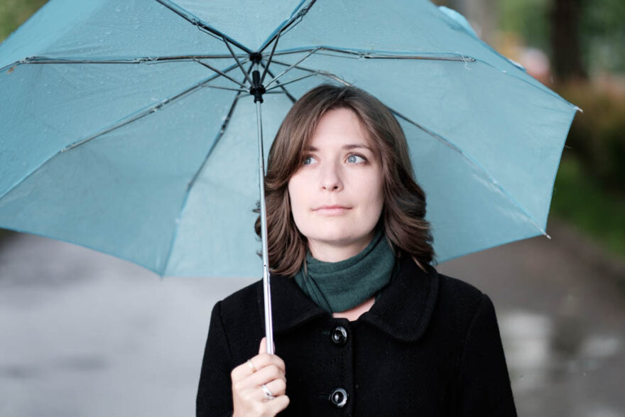 Woman with a light blue umbrella