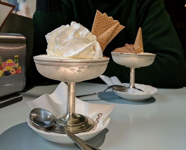 Two ice creams served on an elegant cup in an Italian café