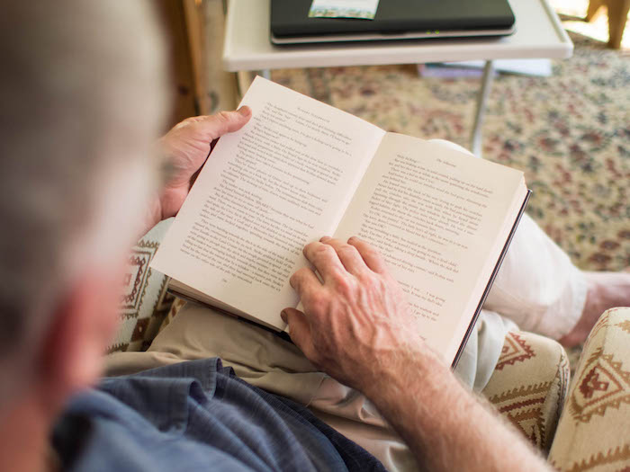 Man reading book in the living room