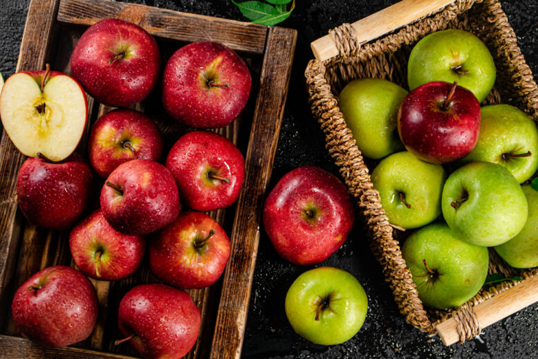 Assortment of red and green apples on the table.