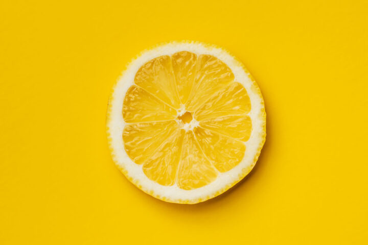 Slice of lemon in yellow background