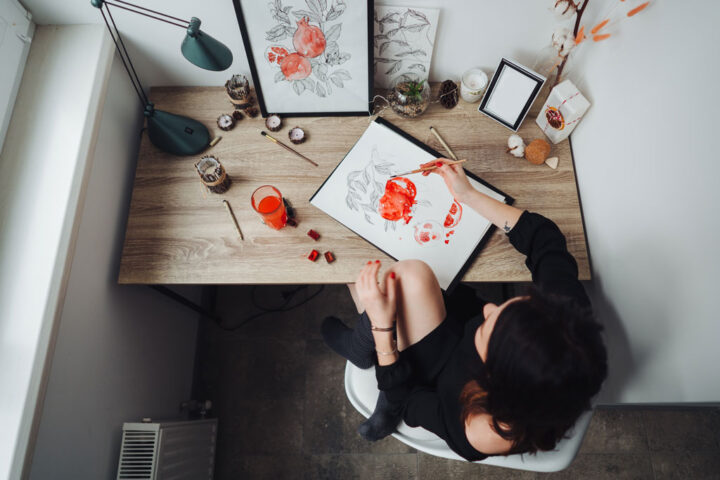 Young woman painting on her desk