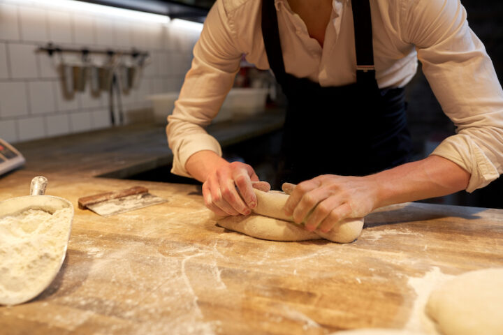 baker hands kneading the dough