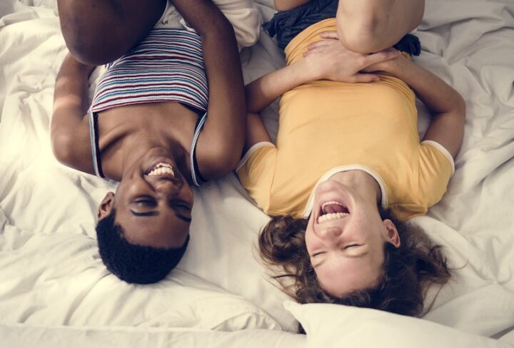 Women lying on the bed and laughing