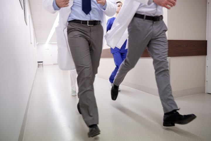 close up of medics or doctors running along hospital corridor