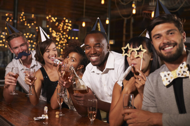 Friends celebrating New Year’s Eve at a party in a bar