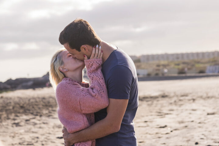 young couple kissing on the beach