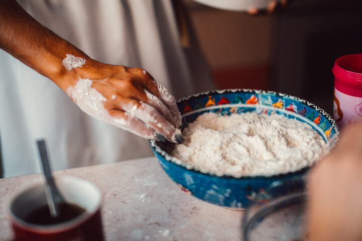 flour in a bowl and Mama's hands in flour