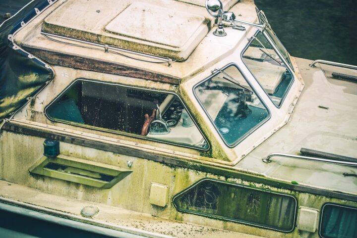 Abandoned Dirty Motorboat in the Marina. Closeup Photo.