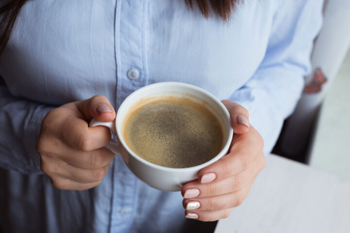 Female hands with coffee drink