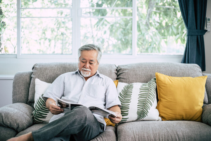 Old man reading at living room