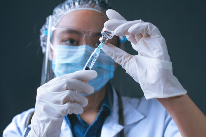 asian doctor preparing vaccine