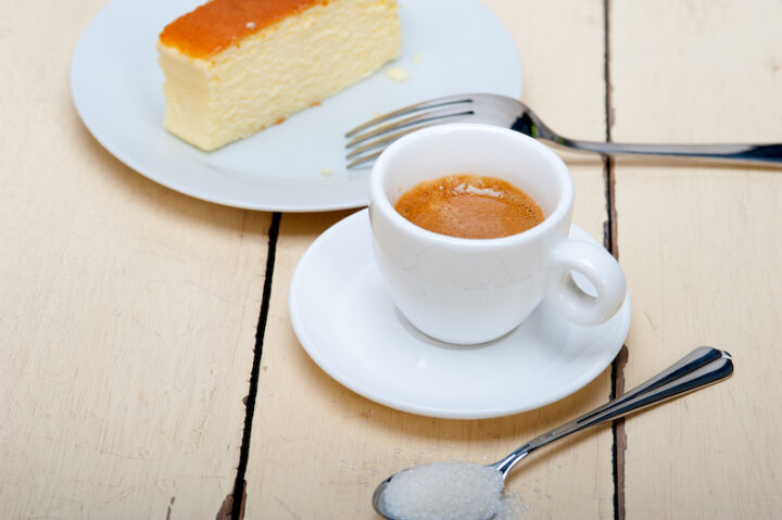 italian espresso coffee and cheese cake over white wood table