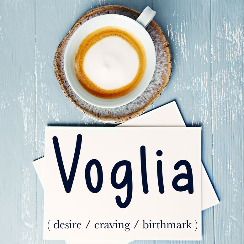 cover image with the word “voglia” and its translation written on a notepad next to a cup of coffee