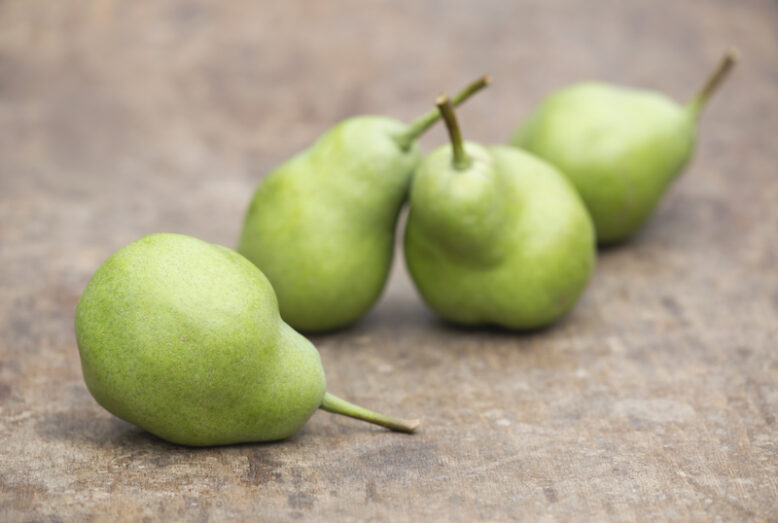 Green pears on a wooden table