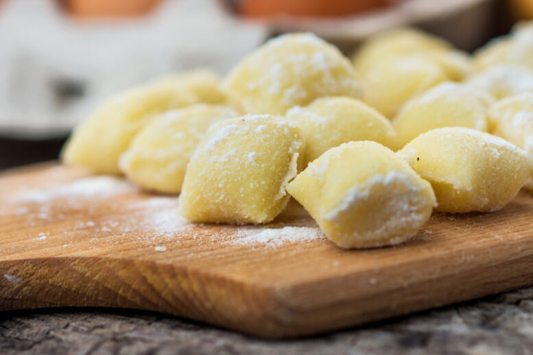 Uncooked homemade gnocchi on  cutting board