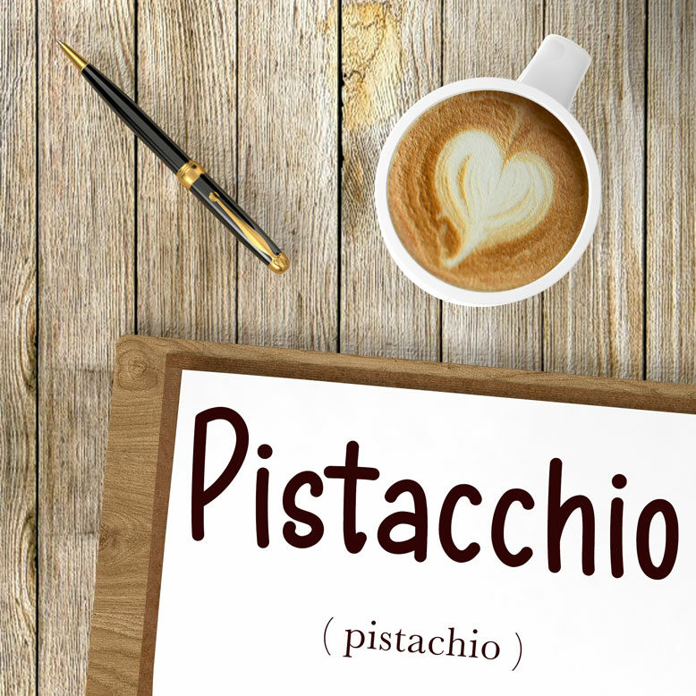 cover image with the word “pistacchio” and its translation written on a notepad next to a cup of cofee