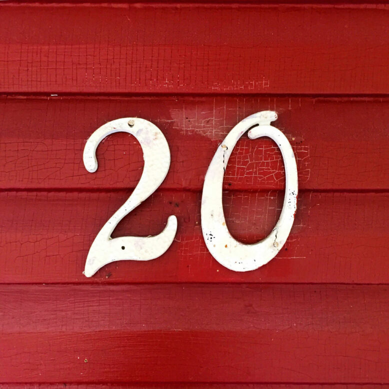 The number 20 on distressed crimson home siding