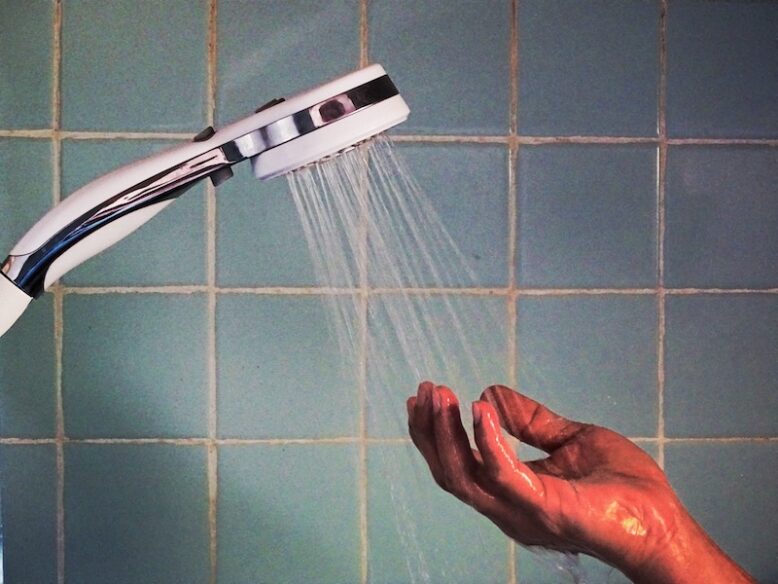 hand under shower wand