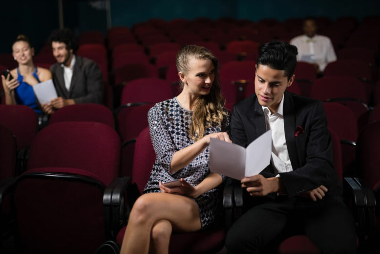 Happy Couple reading in theatre