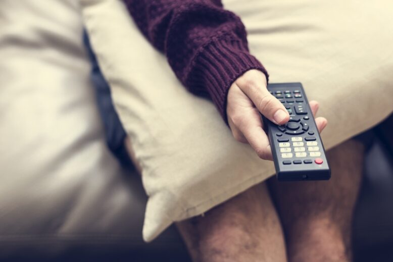 Hand holding television remote control