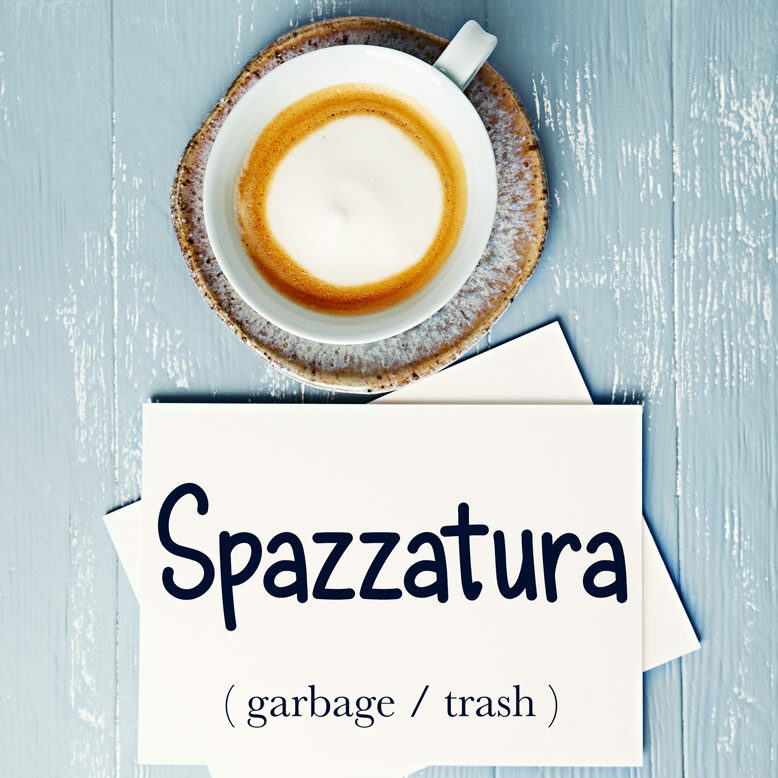 cover image with the word “spazzatura” and its translation written on a notepad next to a cup of coffee
