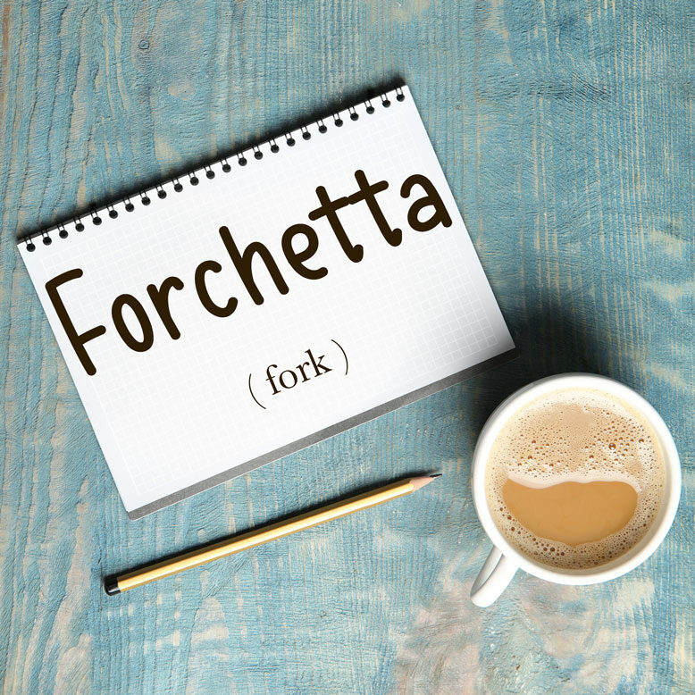 cover image with the word “forchetta” and its translation written on a notepad next to a cup of coffee