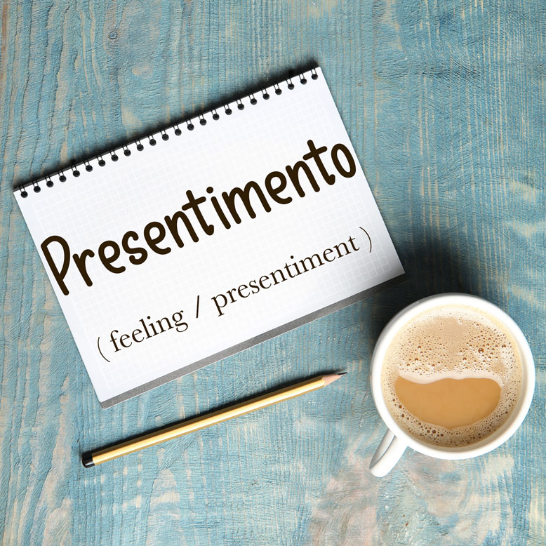 cover image with the word “presentimento” and its translation written on a notepad next to a cup of coffee