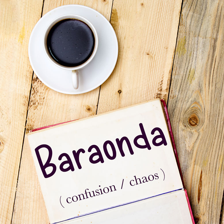 cover image with the word “baraonda” and its translation written on a notepad next to a cup of coffee