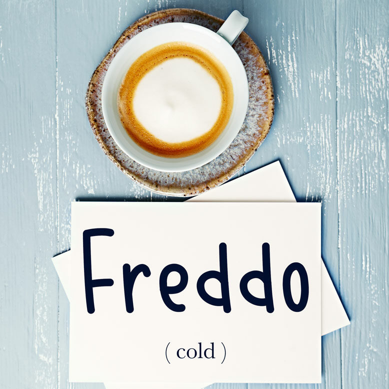 cover image with the word “freddo” and its translation written on a notepad next to a cup of coffee