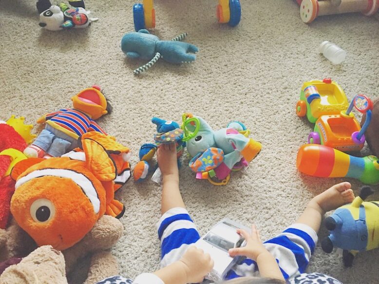 Various toys on the floor in kid's bedroom