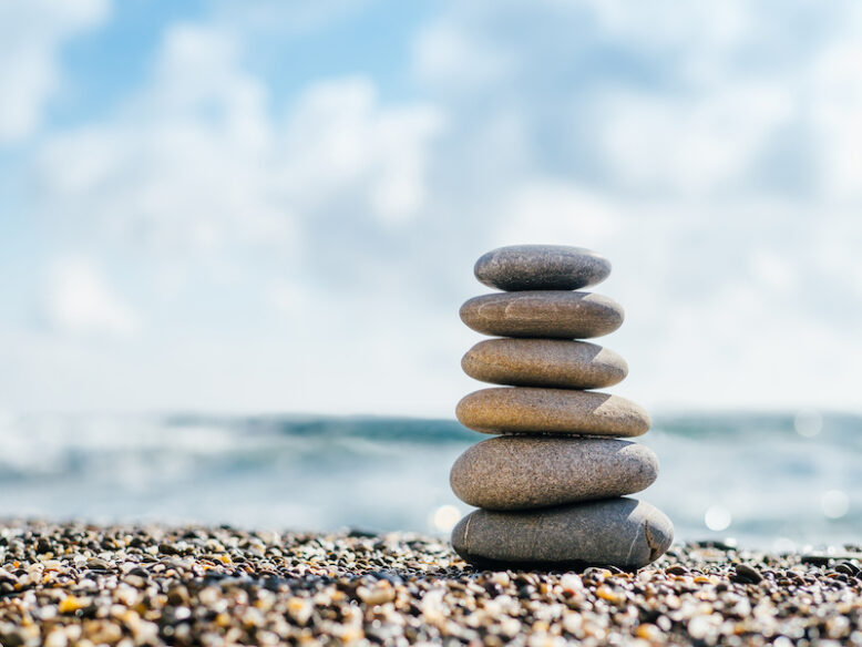Stones balance on beach with copy space for text or design.