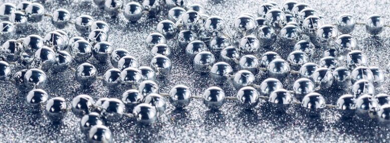 Silver garland beads on silver glitter background
