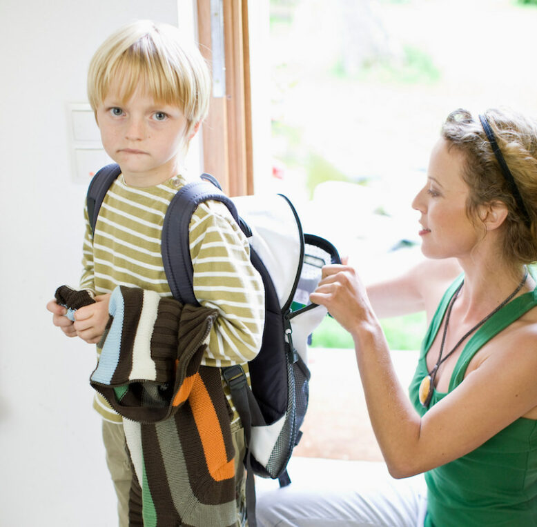 mother getting her son ready for school