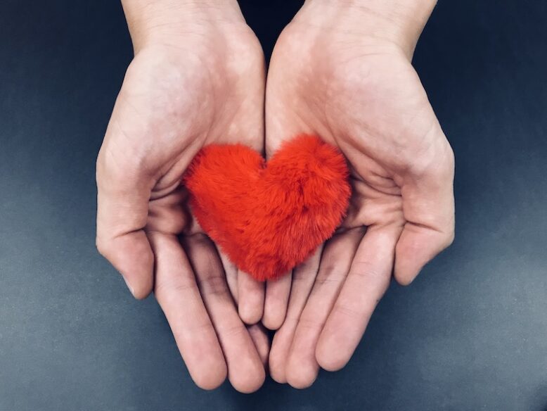 hands holding a fluffy heart
