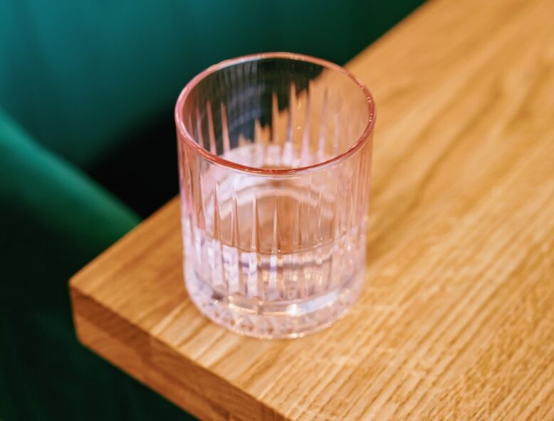 A glass at the edge of the table