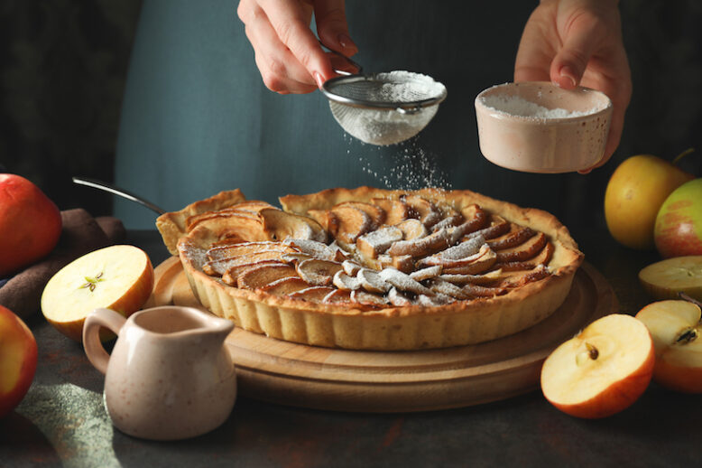 Concept of cooking apple pie on dark background