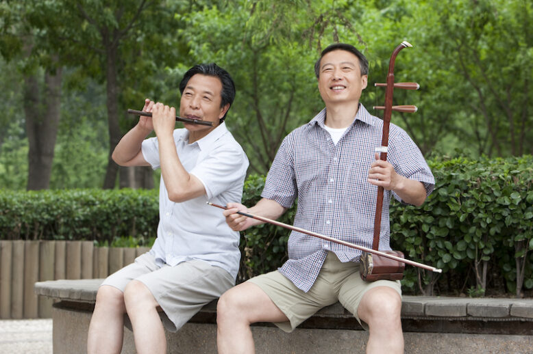 Old men Chinese playing traditional instrument in park