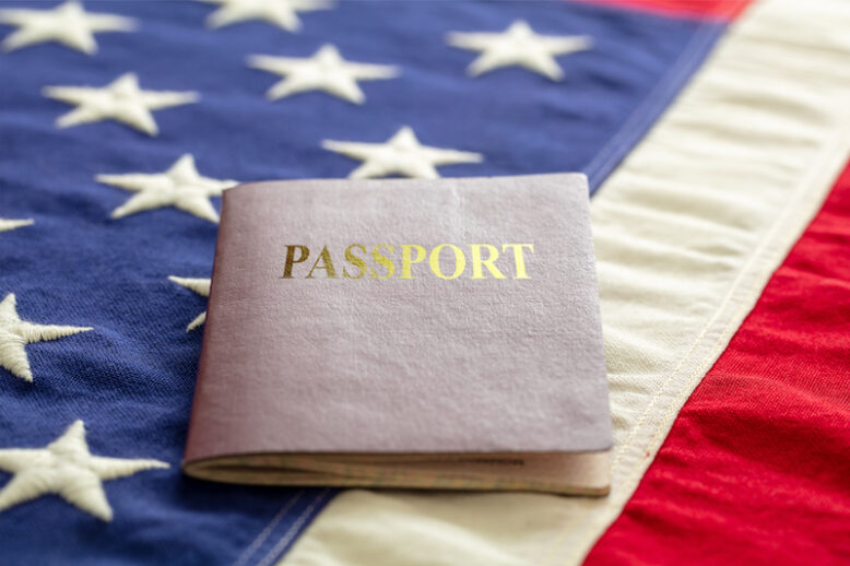 Passport on USA flag background, closeup view. Immigration, United States of America visa concept