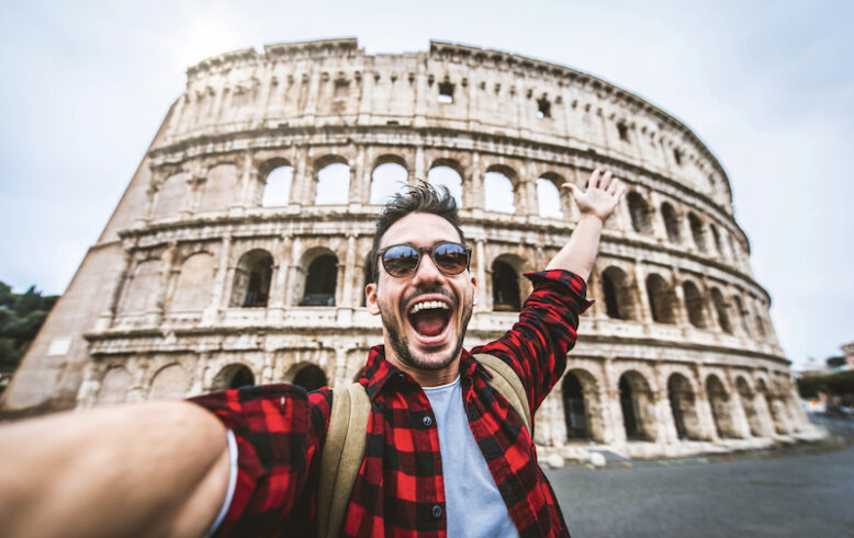 Happy tourist visiting Colosseum in Rome.