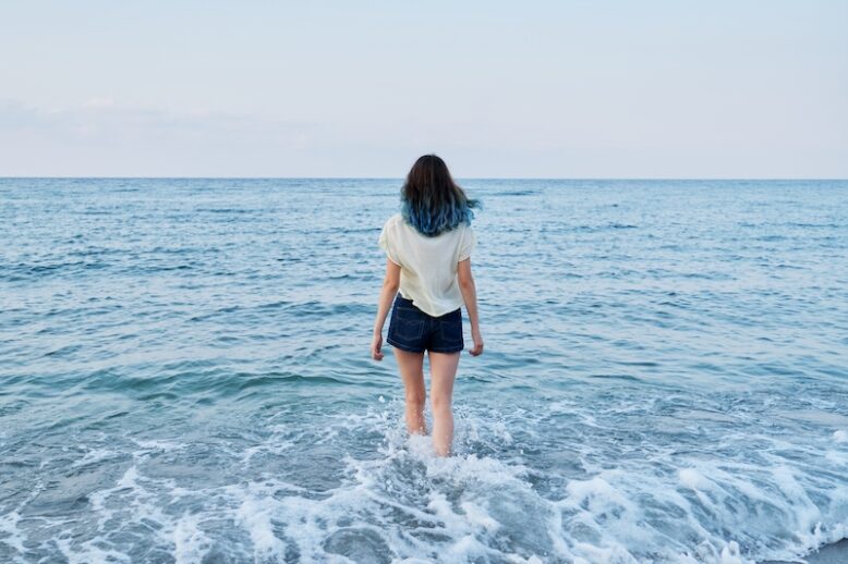 Teenager girl enjoying sea water.