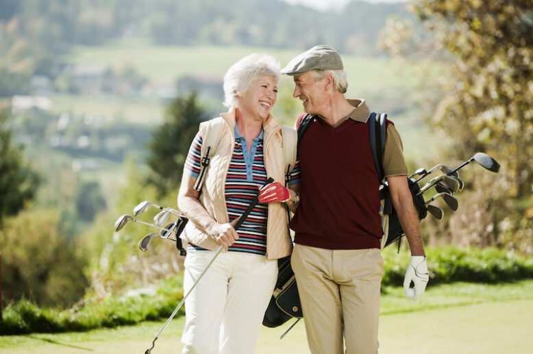 Italy, Kastelruth, Mature couple on golf course, smiling