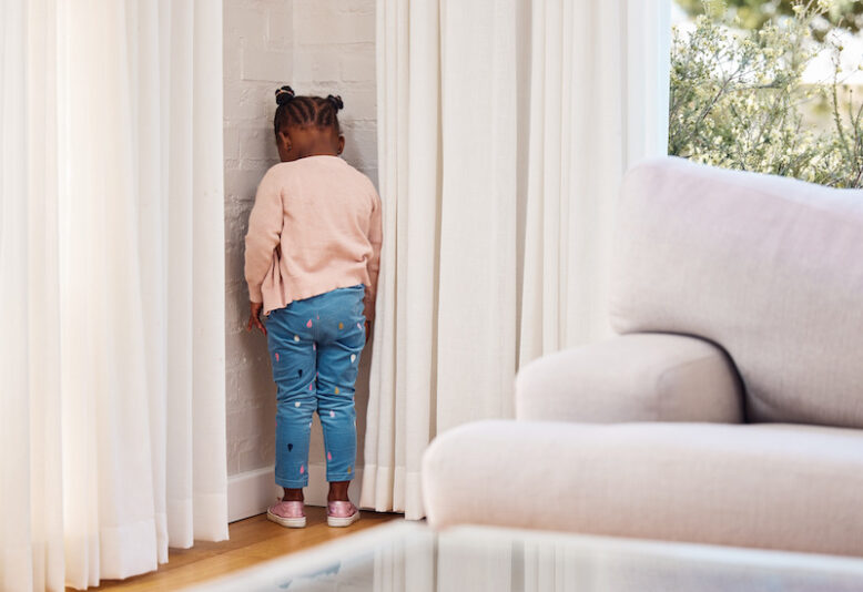 Shot of a little girl standing in the corner at home