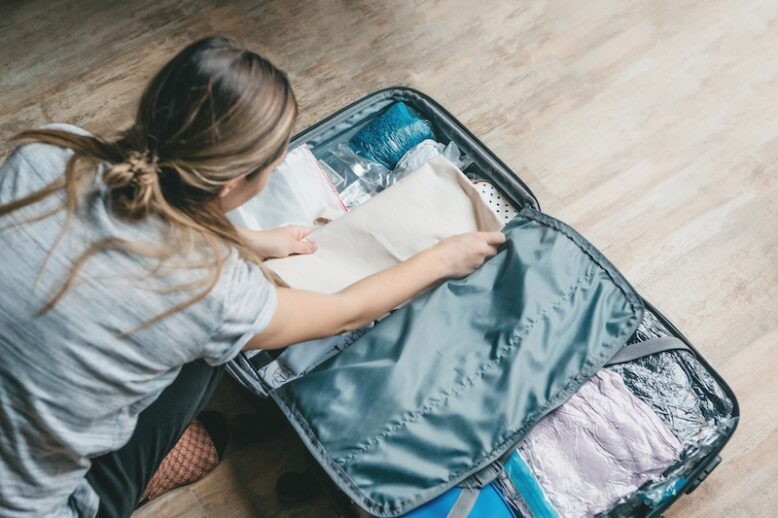 girl packing a suitcase