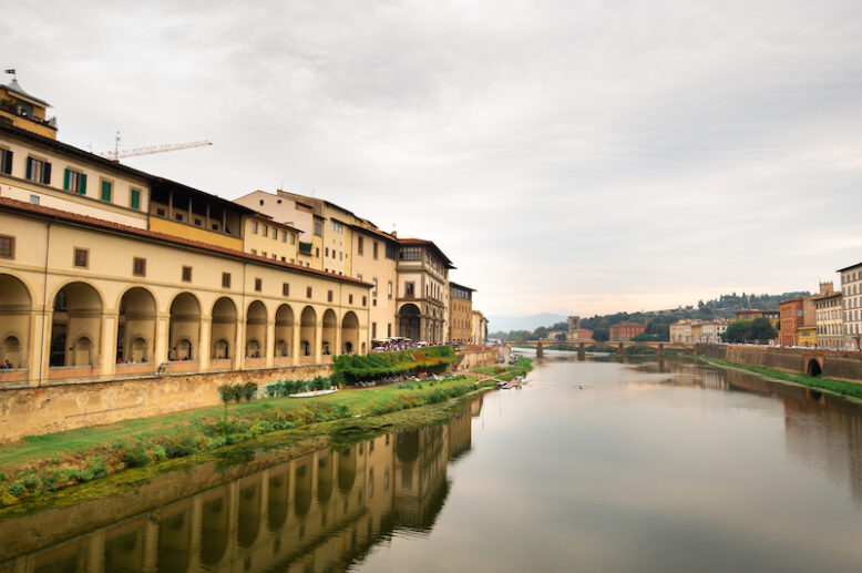 The Uffizi Gallery and the Arno River taken from the Ponte Vecchio bridge on the Arno River in Florence Italy.