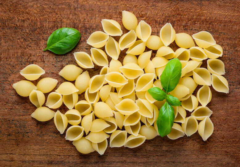 Yellow Conchiglie Rigate PAsta with basil leaves