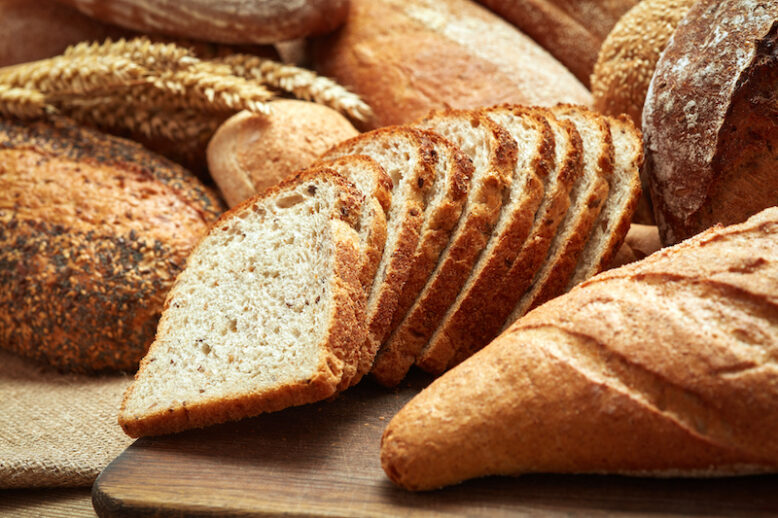 Heap of sliced bread on wooden background