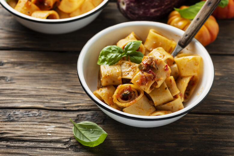 Italian tupe of pasta calamarata with vegetarian sauce, rustica style and selective focus
