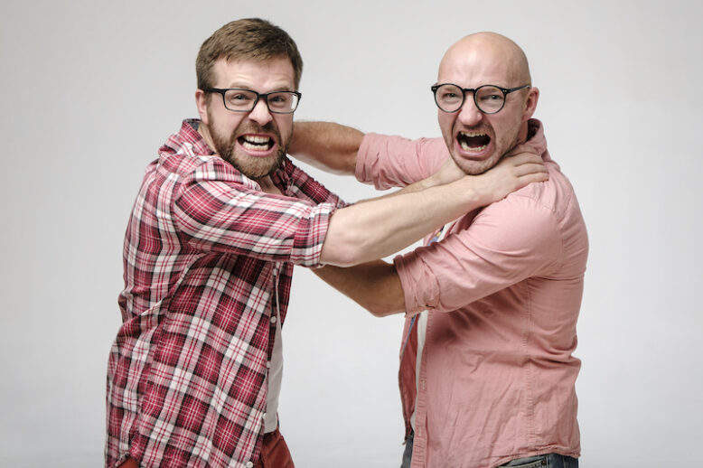 Two men in glasses strangle each other